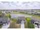 Aerial shot capturing a neighborhood with houses surrounding a scenic pond and expansive community lawns at 991 Terra Ln, Franklin, IN 46131