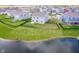 Aerial view of a home with a green lawn and a pond view and surrounded by a black metal fence at 991 Terra Ln, Franklin, IN 46131