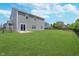 Grassy backyard with black fencing surrounding the yard and a view of the rear of the home at 991 Terra Ln, Franklin, IN 46131
