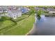 Backyard view of home with pond access, fence, and manicured lawn at 991 Terra Ln, Franklin, IN 46131