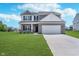 Charming two-story home with a well-manicured lawn and brick accents, providing great curb appeal at 991 Terra Ln, Franklin, IN 46131