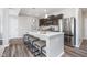 Open kitchen with granite countertops, stainless steel appliances, and a functional island with barstool seating at 991 Terra Ln, Franklin, IN 46131