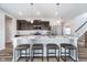 Modern kitchen with stainless steel appliances, a spacious island with seating, and stylish backsplash at 991 Terra Ln, Franklin, IN 46131
