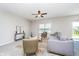 Cozy living room featuring plush seating, a ceiling fan, and ample natural light from a large window at 991 Terra Ln, Franklin, IN 46131
