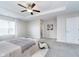 A view of the main bedroom highlighting the neutral walls, plush carpet, ceiling fan, and ensuite at 991 Terra Ln, Franklin, IN 46131