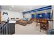 Finished basement rec room with comfortable seating, a table, and sporty decor at 9910 Suncoral Cir, Fishers, IN 46038