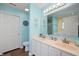 Bright bathroom with double sinks, white cabinetry, and modern fixtures at 9910 Suncoral Cir, Fishers, IN 46038