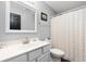 Clean bathroom featuring a single sink vanity, a large mirror, and a shower with a curtain at 9910 Suncoral Cir, Fishers, IN 46038