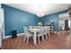 Inviting dining area with a large table, seating for eight, and stylish decor on a blue accent wall at 9910 Suncoral Cir, Fishers, IN 46038