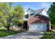 Traditional two-story home with brick accents, attached garage, and mature trees at 9910 Suncoral Cir, Fishers, IN 46038