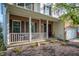 Attractive home showcasing a covered front porch with white railings and manicured landscaping around the property at 9910 Suncoral Cir, Fishers, IN 46038