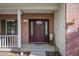 Inviting entryway featuring a brick facade, decorative glass door, and classic outdoor lighting fixtures at 9910 Suncoral Cir, Fishers, IN 46038