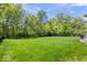 Expansive backyard with lush lawn and mature trees offering privacy and space at 10444 Collingswood Ln, Fishers, IN 46037