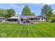 Beautiful backyard featuring a deck with outdoor furniture and a well-maintained lawn at 10444 Collingswood Ln, Fishers, IN 46037