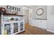 Charming bar area with a glass-front cabinet, mirrored backsplash, and stylish decor at 10444 Collingswood Ln, Fishers, IN 46037