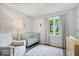 Bedroom with crib, natural light, and comfortable chair at 10444 Collingswood Ln, Fishers, IN 46037