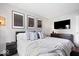 Neutral bedroom with a large bed and decorative wall art at 10444 Collingswood Ln, Fishers, IN 46037