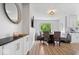Cozy dining area featuring seating for six, modern lighting, and bright window at 10444 Collingswood Ln, Fishers, IN 46037