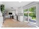 Open-concept kitchen with backyard deck access, stainless appliances, and dining area at 10444 Collingswood Ln, Fishers, IN 46037