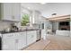 Bright kitchen with white cabinetry, stainless steel appliances, and a view into the living area at 10444 Collingswood Ln, Fishers, IN 46037