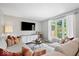 Comfortable living room with a sectional sofa, large window, and modern decor at 10444 Collingswood Ln, Fishers, IN 46037