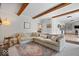 Comfortable living room featuring exposed wood beams and neutral decor at 10444 Collingswood Ln, Fishers, IN 46037