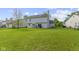 Large, grassy backyard showcasing the home's rear exterior and neighboring properties, ideal for outdoor enjoyment at 10616 Bartley Dr, Indianapolis, IN 46236
