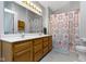 Bathroom featuring double vanity, a decorative shower curtain, and recessed lighting at 10616 Bartley Dr, Indianapolis, IN 46236