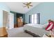 Comfortable bedroom featuring high ceiling, ceiling fan, and a wall-mounted television at 10616 Bartley Dr, Indianapolis, IN 46236