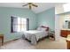 Bright bedroom with vaulted ceiling, large window, and ensuite bathroom at 10616 Bartley Dr, Indianapolis, IN 46236
