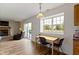 A dining table with a fireplace and outside view through sliding doors at 10616 Bartley Dr, Indianapolis, IN 46236