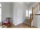 Bright foyer featuring a staircase with wooden banister and views of the living area with beautiful floors at 10616 Bartley Dr, Indianapolis, IN 46236