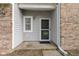 Close-up of the front door with brick and vinyl siding, showcasing the entrance to the home at 10616 Bartley Dr, Indianapolis, IN 46236