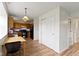 A kitchen and dining area with wood cabinets, black appliances, and a view to a living room at 10616 Bartley Dr, Indianapolis, IN 46236