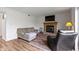 A living room features a fireplace, tv, sofa, chair, and wood laminate flooring at 10616 Bartley Dr, Indianapolis, IN 46236