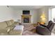 A living room featuring a wood burning fireplace, and comfortable furnishings at 10616 Bartley Dr, Indianapolis, IN 46236