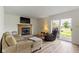 A living room featuring a fireplace, comfortable seating, and sliding glass doors to the outside at 10616 Bartley Dr, Indianapolis, IN 46236