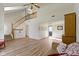 Inviting living room with staircase, vaulted ceiling, and modern wood-look floors at 10616 Bartley Dr, Indianapolis, IN 46236