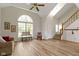 Bright living room featuring a vaulted ceiling, large windows, and modern flooring at 10616 Bartley Dr, Indianapolis, IN 46236