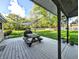 Relaxing back deck with a picnic table, sun shade and view of the expansive backyard at 10751 N Kitchen Rd, Mooresville, IN 46158