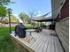 Back deck featuring a grill, glass table, and sunshade for enjoyable outdoor gatherings at 10751 N Kitchen Rd, Mooresville, IN 46158