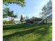 Spacious backyard with a patio, grill, and mature trees provides ample outdoor living space at 10751 N Kitchen Rd, Mooresville, IN 46158