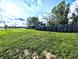 A fenced backyard with lush lawn offers privacy and security for outdoor activities at 10751 N Kitchen Rd, Mooresville, IN 46158