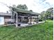 Relaxing backyard patio with comfortable seating, grill, and lush green lawn at 10751 N Kitchen Rd, Mooresville, IN 46158