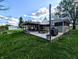 View of the backyard patio featuring a grill and a picnic table under a sunshade at 10751 N Kitchen Rd, Mooresville, IN 46158