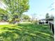 Expansive backyard showing the green lawn, partial view of the house, and the outdoor living space at 10751 N Kitchen Rd, Mooresville, IN 46158