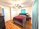 Cozy bedroom with hardwood floors, ceiling fan, and a closet at 10751 N Kitchen Rd, Mooresville, IN 46158