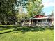 Charming home exterior featuring a well-manicured lawn and mature trees at 10751 N Kitchen Rd, Mooresville, IN 46158