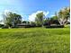 Property features a large lawn with mature trees providing ample green space at 10751 N Kitchen Rd, Mooresville, IN 46158
