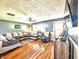 Bright and airy living room with hardwood floors, neutral walls, and cozy seating at 10751 N Kitchen Rd, Mooresville, IN 46158
